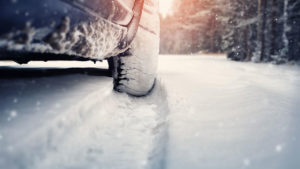 A car tire driving through snow